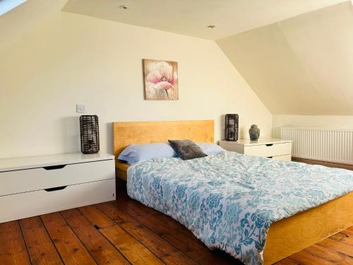 a bedroom with a bed and a dresser in it at Gorgeous House by City Walls in Canterbury