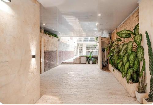 a hallway with a mural of plants on the wall at Casa con Piscina Privada Playas del Mar in Cartagena de Indias