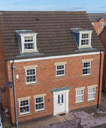 a large brick building with three windows and a roof at Spacious 5-Bed Detached House, Sleeps 10, Parking in Desborough