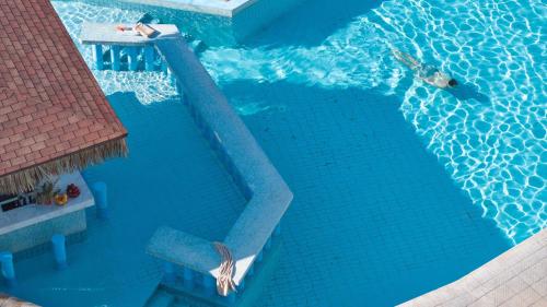 an overhead view of a swimming pool with two people in it at Kiotari Miraluna Beach Resort in Kiotari