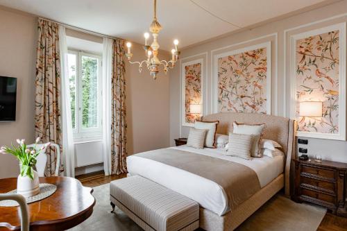 een slaapkamer met een groot bed en een kroonluchter bij Cappuccina Country Resort in San Gimignano