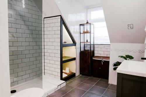 a bathroom with a shower and a sink at Muthu Queens Hotel, Oban in Oban