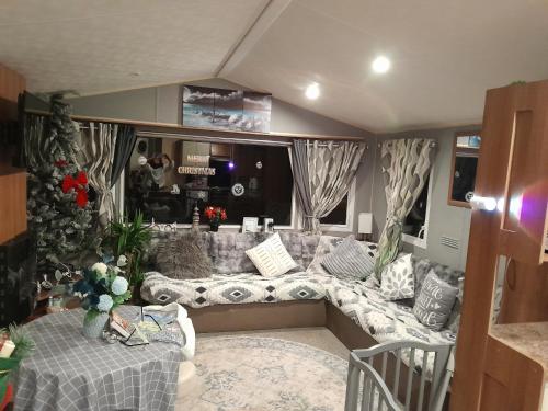 a living room with a couch and a table at Static caravan - sleeps 8 in Great Driffield