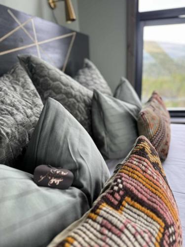 a couch with pillows and a blanket on it at Eagle Nest Eco Lodge in Sel