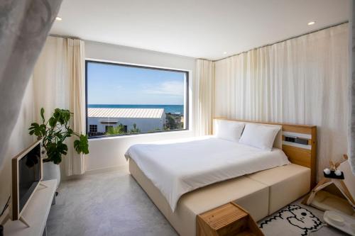 Postel nebo postele na pokoji v ubytování Hyupjae Hyun Stay