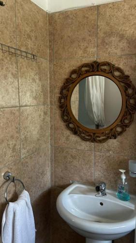 a bathroom with a sink and a mirror on the wall at Ark Gastehuis and Williston Mall in Williston