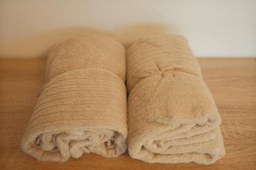 two towels laying on top of a wooden floor at Pension Zum Waldrand in Sinsheim