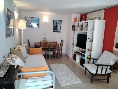 a living room with a couch and a dining room at Manta Rota Beach,open space apartment , terrace,garden in Manta Rota