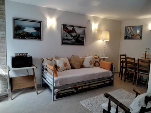 a living room with a couch and a table at Manta Rota Beach,open space apartment , terrace,garden in Manta Rota