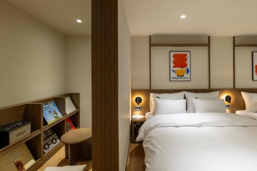 a bedroom with a large white bed in a room at Vinetree Boutique Hotel in Seoul