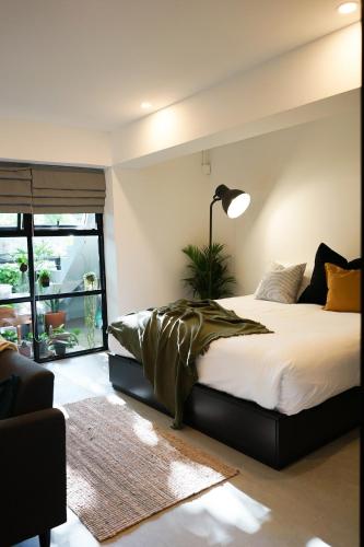 a bedroom with a large bed and a lamp at Tiny home Pana B Private residence 10mins beach in Bophut