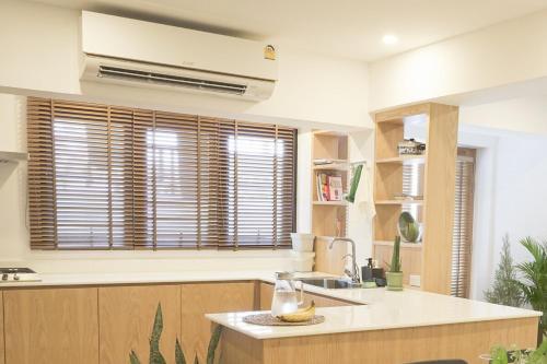 a kitchen with a sink and a window with blinds at Tiny home Pana B Private residence 10mins beach in Bophut