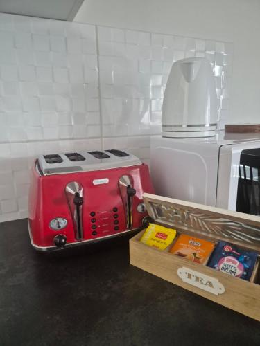 a red toaster sitting on top of a kitchen counter at Apartman Srbac in Srbac