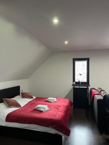 a bedroom with two beds with a red blanket at Apartmán Krahule in Krahule