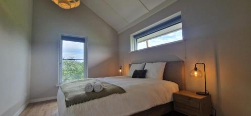 a bedroom with a bed with two slippers on it at Vakantievilla de Broak in Ambt Delden