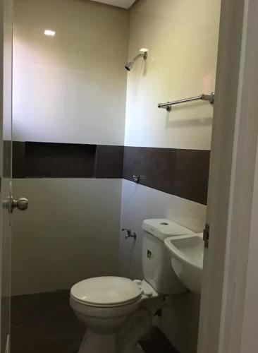a bathroom with a toilet and a sink at Silay Haven Near Airport by One Guest Place 3919B in Silay