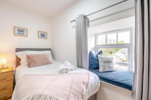 a bedroom with a bed and a window at 3 Bed in Waren Mill oc-gd1928 in Bamburgh