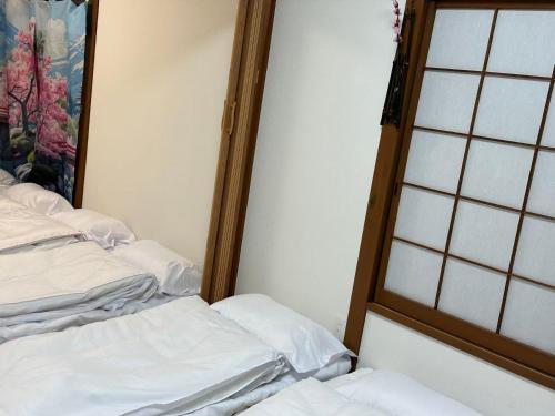 En eller flere senge i et værelse på 双魚の宿板橋