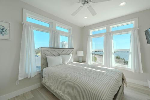 a bedroom with a bed with a view of the ocean at Punta Rassa Pointe by Sun Palace Vacations in Fort Myers