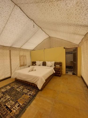 a bedroom with a large bed in a room at Raj Kesari Heritage Camp in Jaisalmer