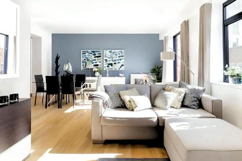 a living room with a couch and a dining room at Welcome London - The York in London