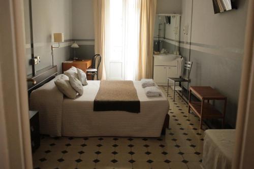 a hotel room with a bed and a bathroom at Albergo Garisenda con terrazza panoramica sulle Due Torri in Bologna
