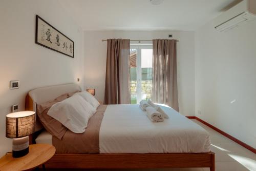 a bedroom with a bed and a window at Trieste - Villa Prosecco in Prosecco