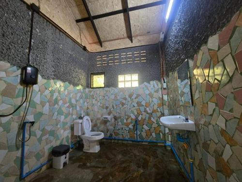 a bathroom with a toilet and a sink at Pirates Bay Resort & Spa in Ko Lanta