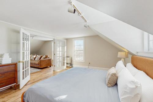 a white bedroom with a bed and a couch at Stowe Mountain Road Retreat in Stowe