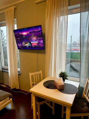 a living room with a table and a tv on the wall at Zentrales Hansa Komfort Apartment in Bremen