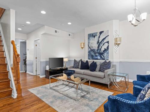 a living room with a couch and a tv at NoMA 3BR Townhome - UnionMarket H St Streetcar in Washington, D.C.