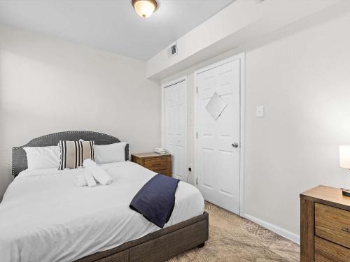 a bedroom with a large bed with white walls at NoMA 3BR Townhome - UnionMarket H St Streetcar in Washington, D.C.