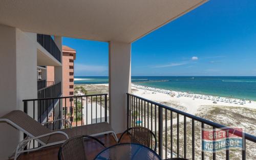 a balcony with chairs and a view of the beach at Phoenix East II 2072 in Orange Beach