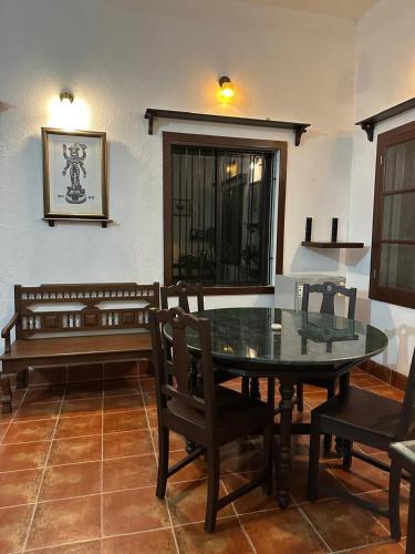 a dining room with a glass table and chairs at Junput Guest House in Bichania