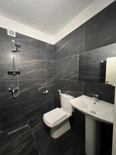 a bathroom with a toilet and a sink at Hotel, Bar, Restaurant Beni in Vlorë