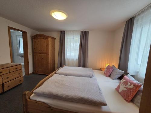 a bedroom with two beds and a dresser at Haus Barbara Ott in St. Blasien