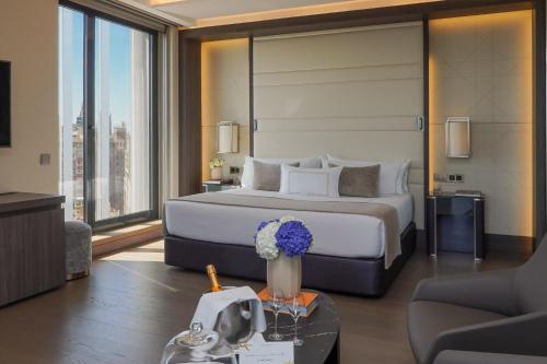a bedroom with a large bed with a large window at VP Plaza España Design in Madrid
