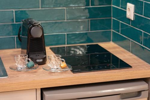 a hair dryer sitting on top of a counter with glasses at Seashell Luxury Residence in Lixouri