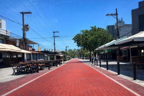a red brick road in a street with tables and benches at Flat Praia do Canto Collection View in Vitória