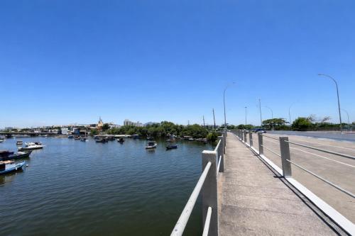 a bridge over a river with boats in the water at Flat Praia do Canto Collection View in Vitória
