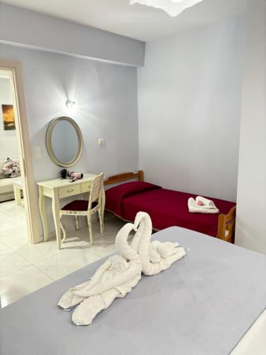 a room with a bed with a towel on the floor at Panorama Apartments in Prinos