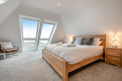 a bedroom with a large bed and two windows at 2 Bed in Tintagel oc-g33170 in Tintagel