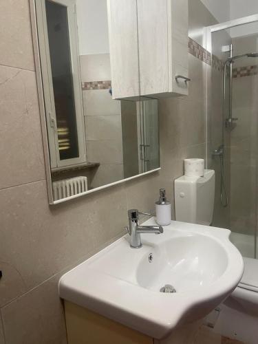 a bathroom with a sink and a mirror and a toilet at VILLA AIDA LAKE VIEW in Lavena Ponte Tresa