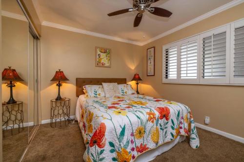 a bedroom with a bed and a ceiling fan at Maalaea Kai Resort 213 in Wailuku