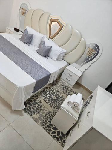 a bedroom with a large bed with a whitevisor at Sunset Senegal in Rufisque