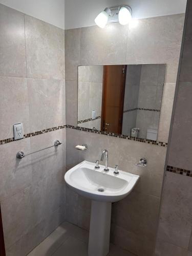 a bathroom with a sink and a mirror at Depto centro in Villa Carlos Paz