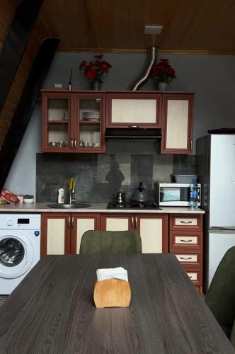 a kitchen with a table with a towel on it at A frame abdul in Quba