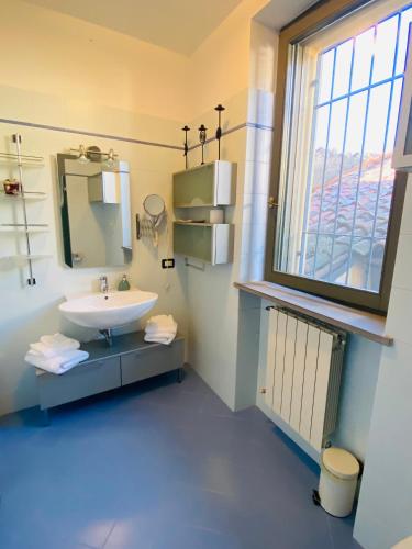 a bathroom with a sink and a window at Amici Miei Rooms in Cremona
