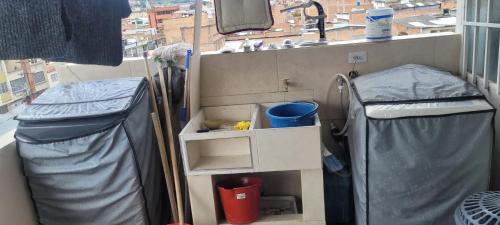 a room with two beds and a sink and a window at Apto con balcon in Pasto