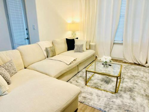 a white living room with a couch and a table at Cozy & Chic Frisco Scape in Frisco